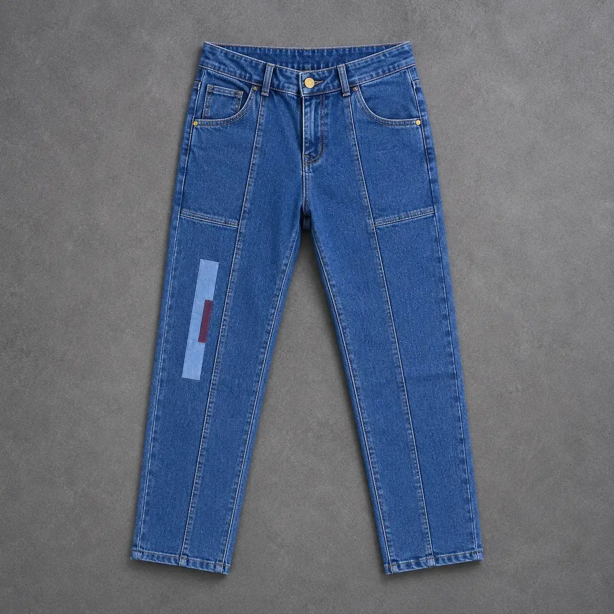 Blue denim jeans on gray backdrop